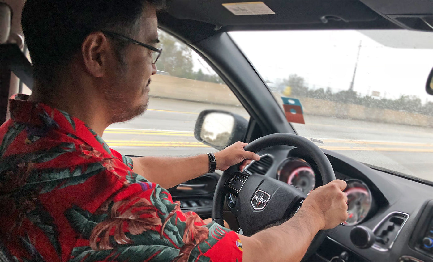 dad driving a minivan in a Magnum PI Aloha shirt